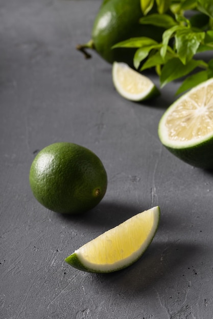 Juicy green limes on grey concrete background Healthy eating detox diet