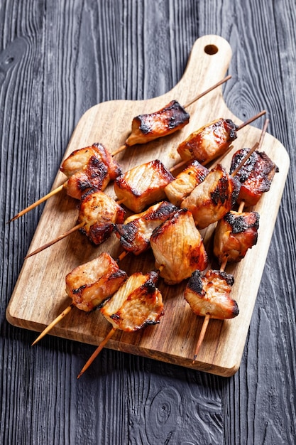 Juicy grilled pork kebabs on a cutting board