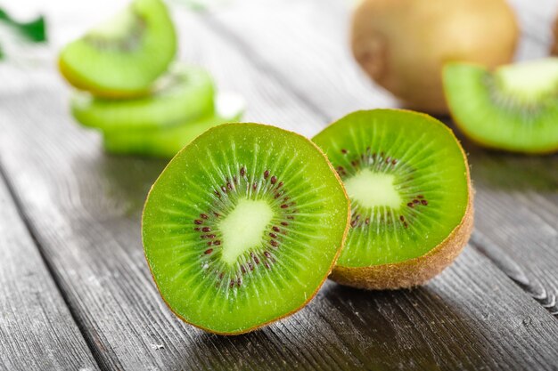 Juicy kiwi fruit on wooden table