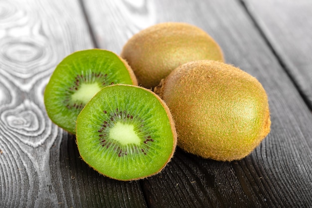 Juicy kiwi fruit on wooden table