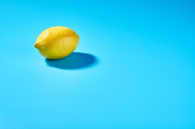 Juicy lemon on blue background. Lemon background.