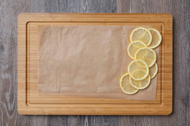 Juicy lemons cut into slices on a kitchen board