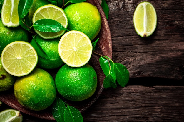 Photo juicy lime with leaves on a plate