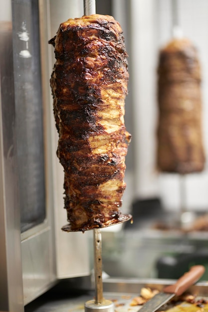 Juicy meat on a spit chicken Meat for shawarma on a spit