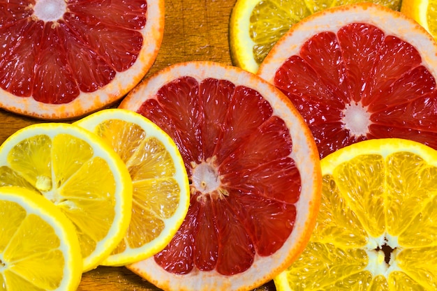 Juicy orange and grapefruit ring close-up as background