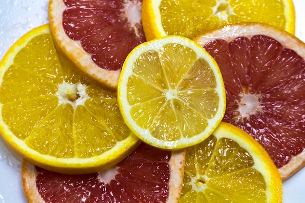 Juicy orange and grapefruit ring close-up as background