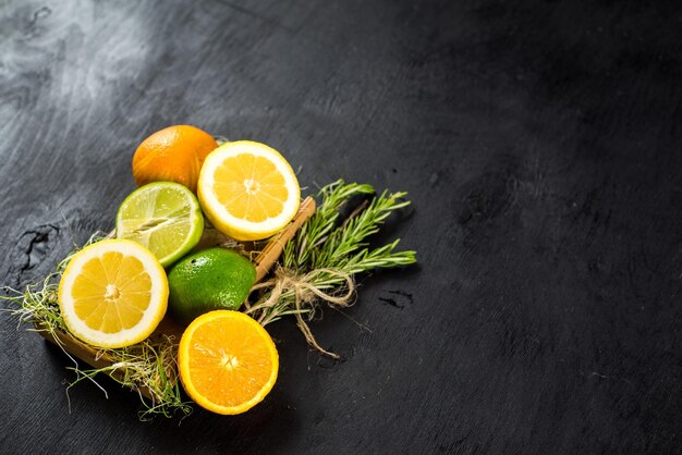 Juicy oranges and limes n black background