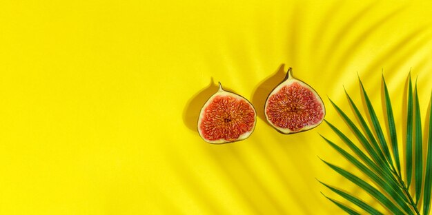 Juicy organic fig cut in half on a yellow background Minimal flat lay copy space