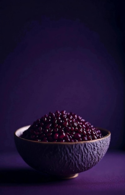 Juicy pomegranate seeds in deep ceramic bowl on dark purple backgroundPlace for textGenerative AI