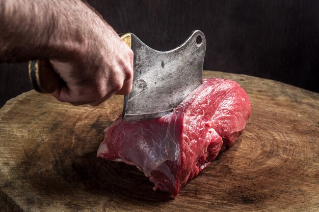 Juicy raw beef steak on wooden table