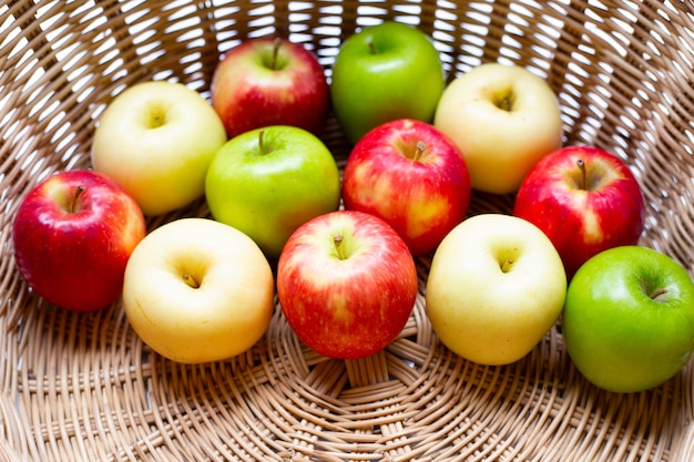 Juicy red, yellow and green apples in a basket