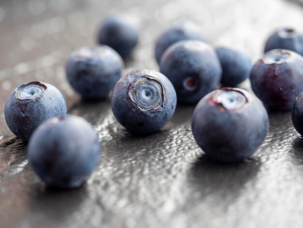 Juicy ripe blueberries on a textured dark background. Close-up, berries, edaa