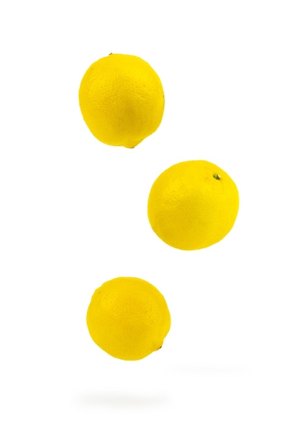 Juicy ripe flying yellow lemons fruit, set of falling delicious lemons on white background.