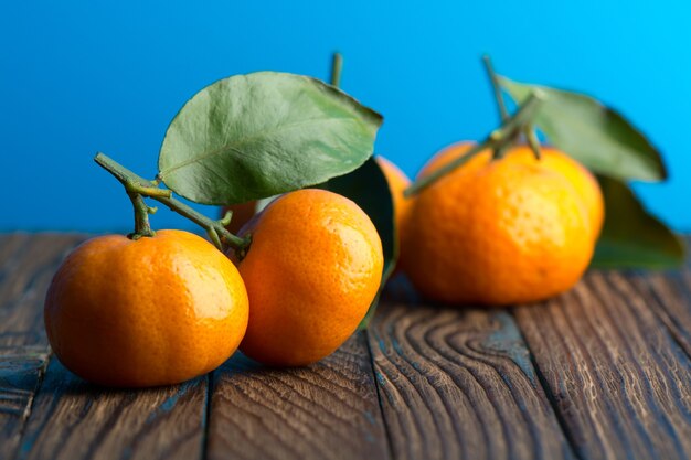 Juicy ripe tangerines on a wooden table