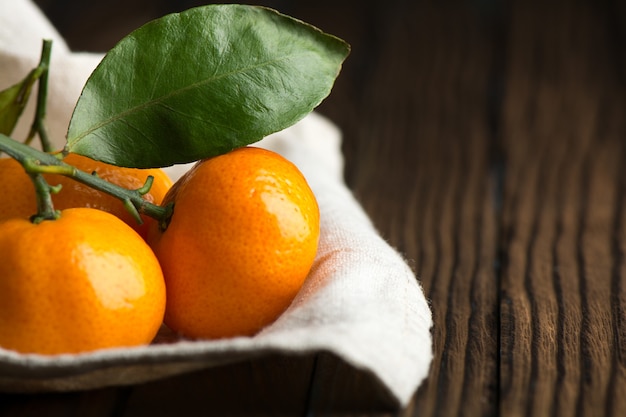 Juicy ripe tangerines on a wooden table