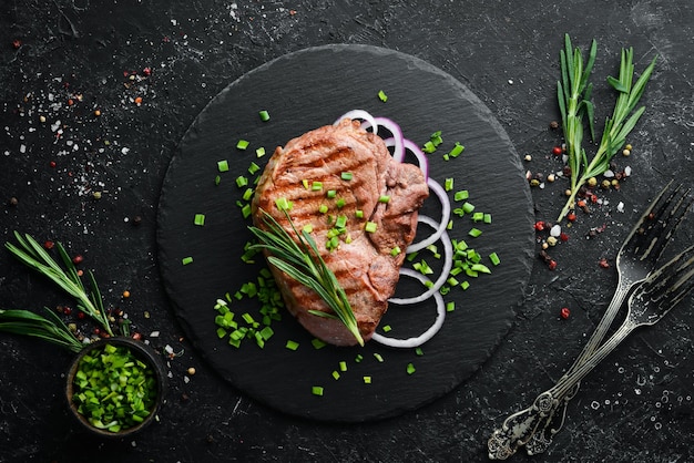 Juicy roasted veal steak with rosemary and spices Top view Free space for your text
