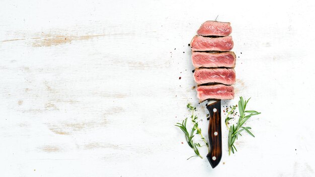 Juicy Steak on the knife Top view Free space for your text