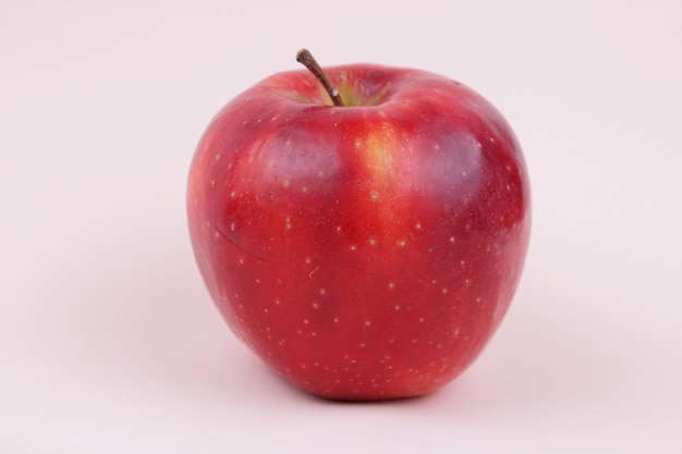 Juicy sweet whole red apple on a light background Healthy food concept Closeup of a red fruit