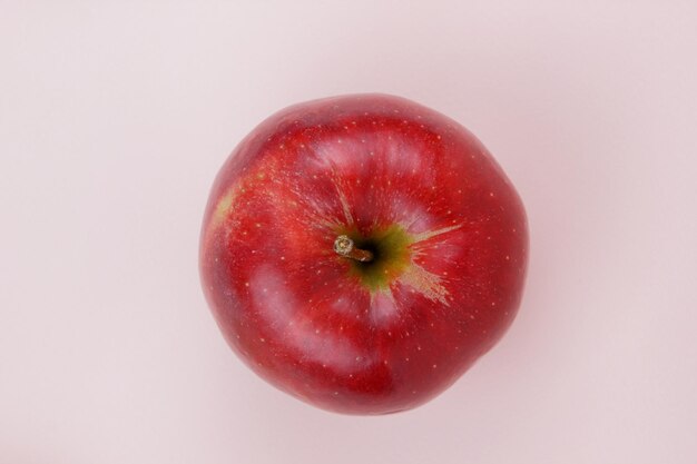 Juicy sweet whole red apple on a light background Healthy food concept Closeup of a red fruit