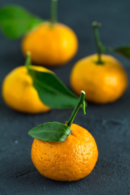 Juicy tangerines on a concrete surface