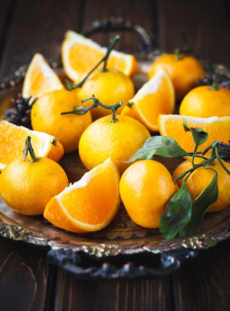 Juicy tangerines in a vintage Christmas dish