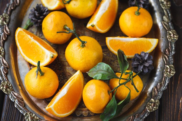 Juicy tangerines in a vintage Christmas dish