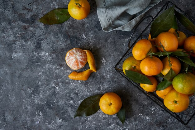 Juicy tangerines with leaves in a basket 