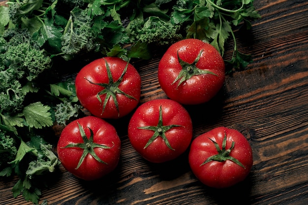 Juicy tomatoes and parsley on a wooden countertop