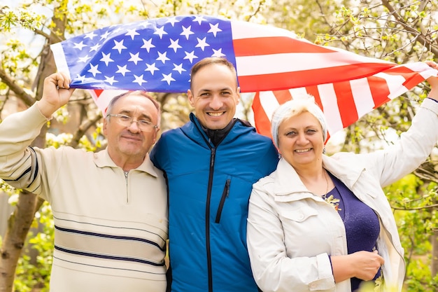 July 4th: American Family Behind US Flag.