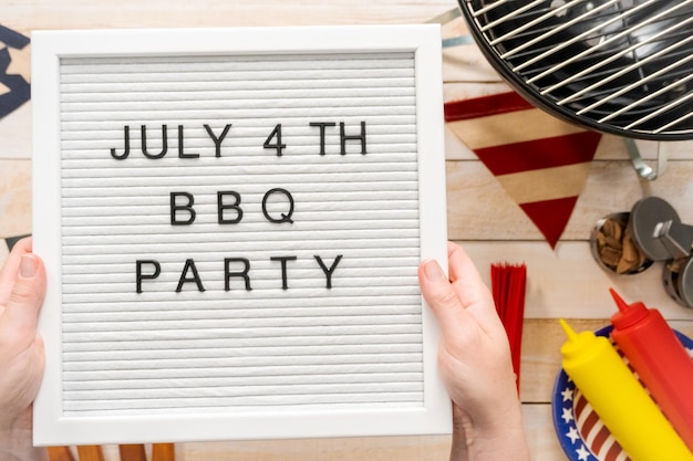 July 4th BBQ Party sign on a white mamo board.