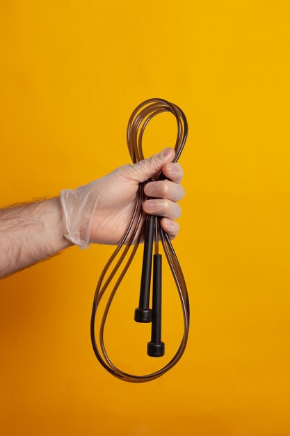 Jump rope holded by a hand with protection glove