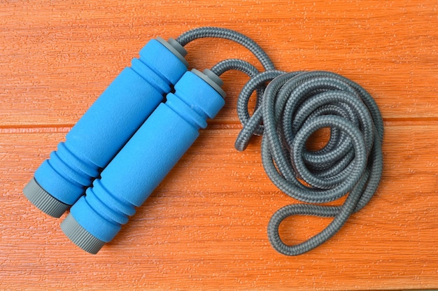 Jump rope isolated on a wooden background