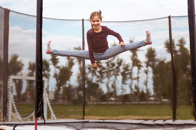 Jumping on Trampoline Little girl jumps on trampoline