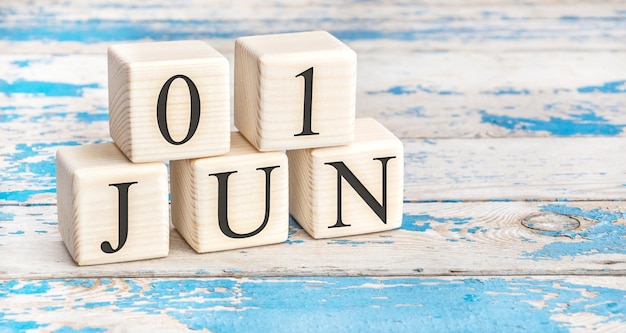 June 1st Wooden cubes with date of 1 June on old blue wooden background