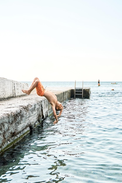 Junior schoolboy unsuccessfully performed backflip from pier into azure sea