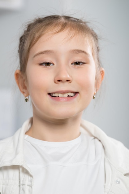 Photo junior schoolgirl demonstrates smile enjoying life at home