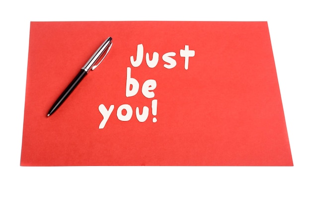 Photo just be you text with pen and plain paper as motivational concept