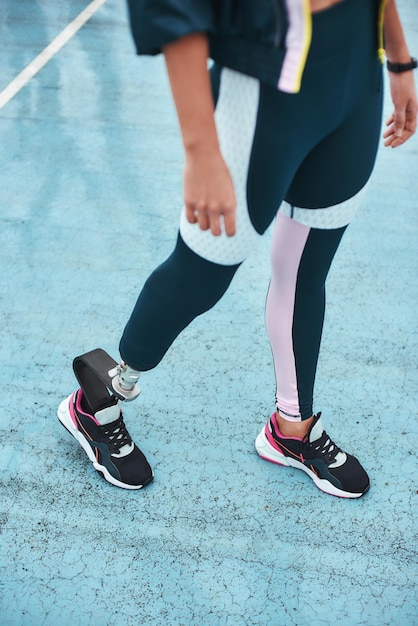 Just keep running cropped image of disabled woman in sportswear with bionic leg standing on