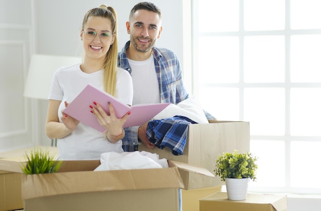 A just married couple unpacking boxes and moving into a new home Positive emotion