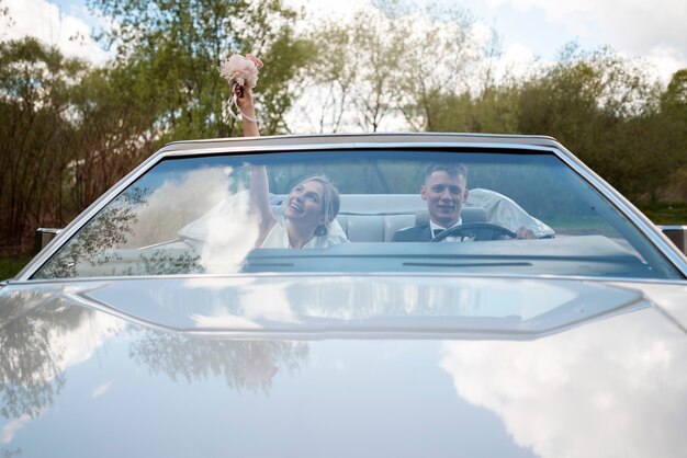 Just married couple with their car