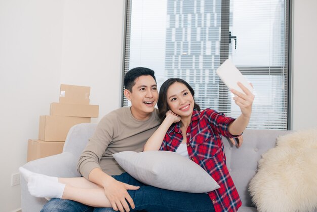 Just married couple of young man and woman feeling unbelievable chilling in their new house