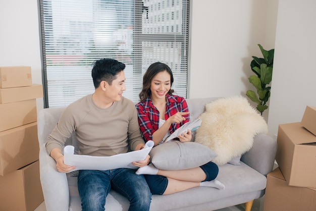 Just married couple of young man and woman feeling unbelievable chilling in their new house