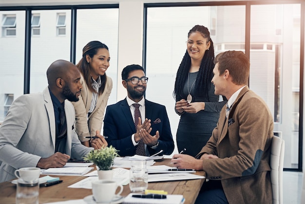 Photo just so were all on the same page shot of a group of young businesspeople having a meeting in a modern office