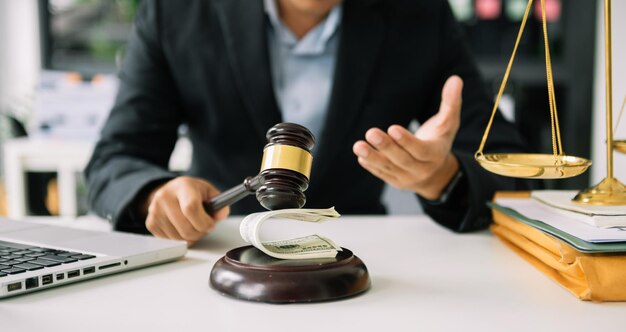 Justice and law concept asian woman lawyer working and judge in a courtroom the gavel working with tablet and laptop and digital tablet computer on white table