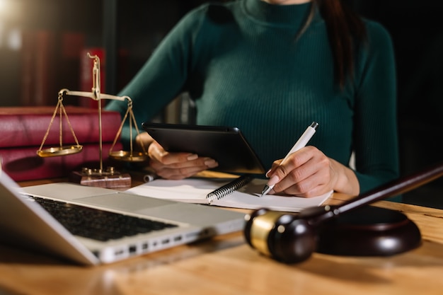 Justice and law concept.Male judge in a courtroom on wooden table and Counselor or Male lawyer working in office. Legal law, advice and justice concept.
