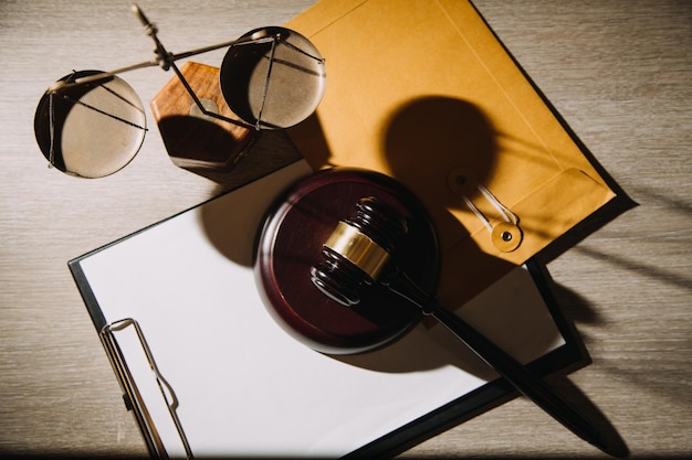 Justice and law conceptmale judge in a courtroom with the gavel\
working with computer and docking keyboard eyeglasses on table in\
morning light