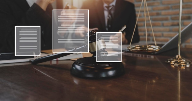 Justice and law conceptMale judge in a courtroom with the gavel working with computer and docking keyboard eyeglasses on table in morning light