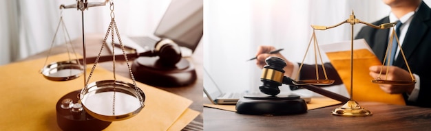 Justice and law conceptMale judge in a courtroom with the gavel working with computer and docking keyboard eyeglasses on table in morning light