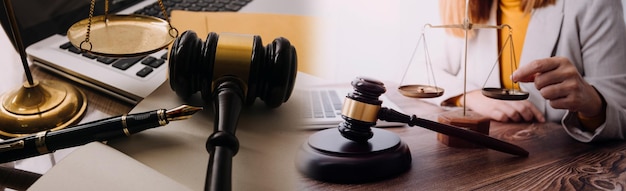 Justice and law conceptMale judge in a courtroom with the gavel working with computer and docking keyboard eyeglasses on table in morning light