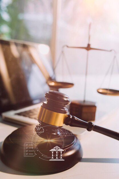 Justice and law conceptMale judge in a courtroom with the gavel working with computer and docking keyboard eyeglasses on table in morning light